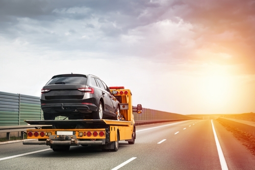 Tow truck providing local towing and roadside assistance to a stalled vehicle in The Woodlands, TX